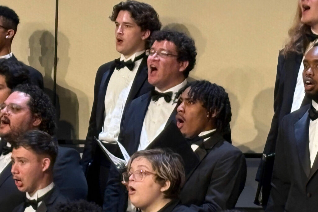 Tenors and basses singing in tuxedos during the performance