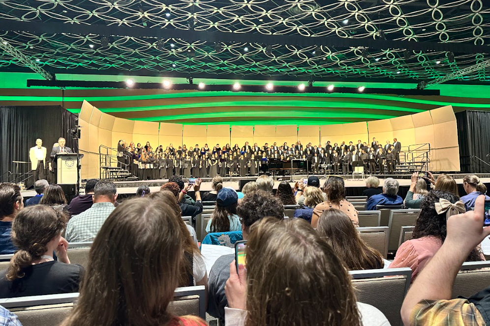 The All-State Choir performing on a green-lit stage at the TMEA convention